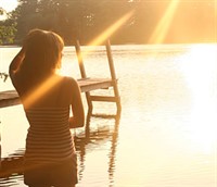 girl in water next to dock